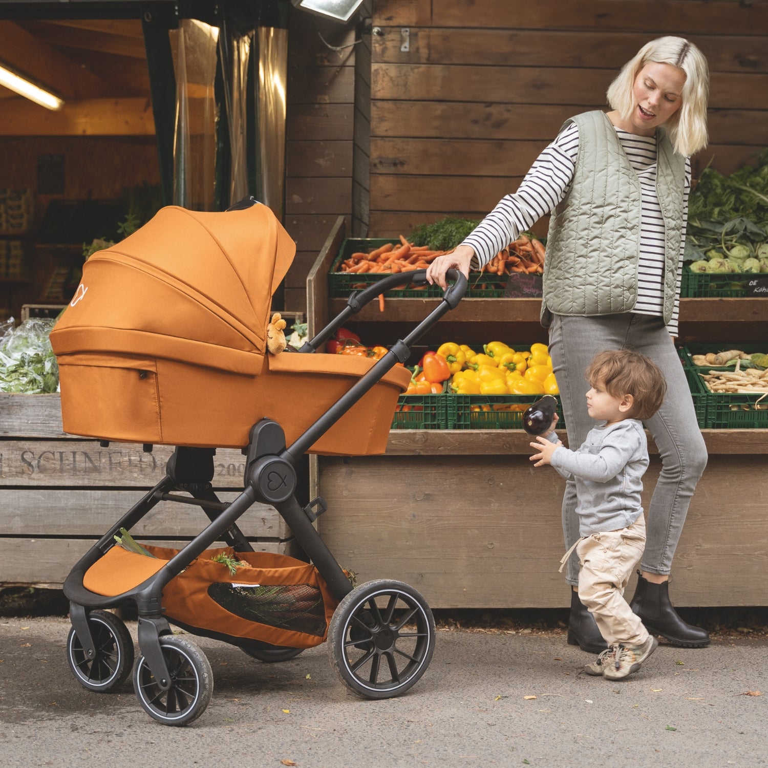 Mutter mit Kind und Kinderwagen auf dem Markt
#farbe_fuchsrot